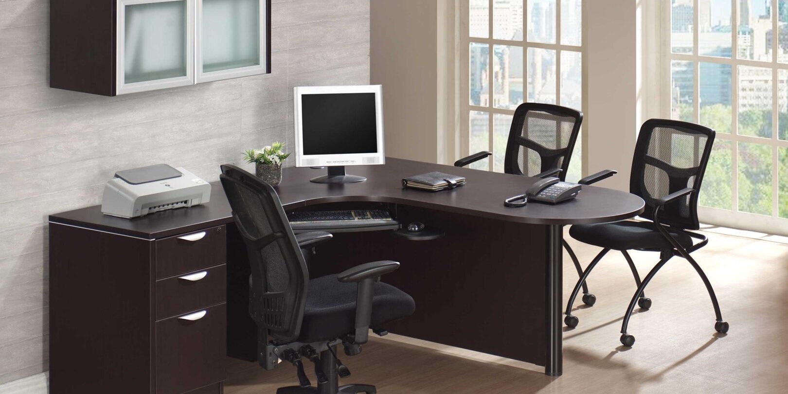 A desk with two chairs and a computer.