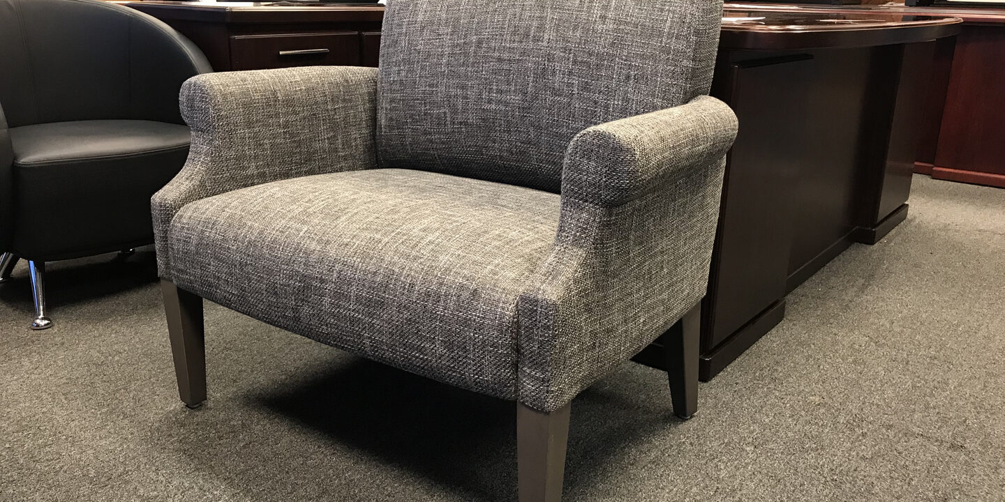 A chair in an office with a desk and chair.